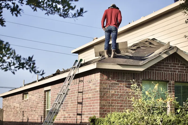 Professional roofer working on a residential roof in Damascus Heights